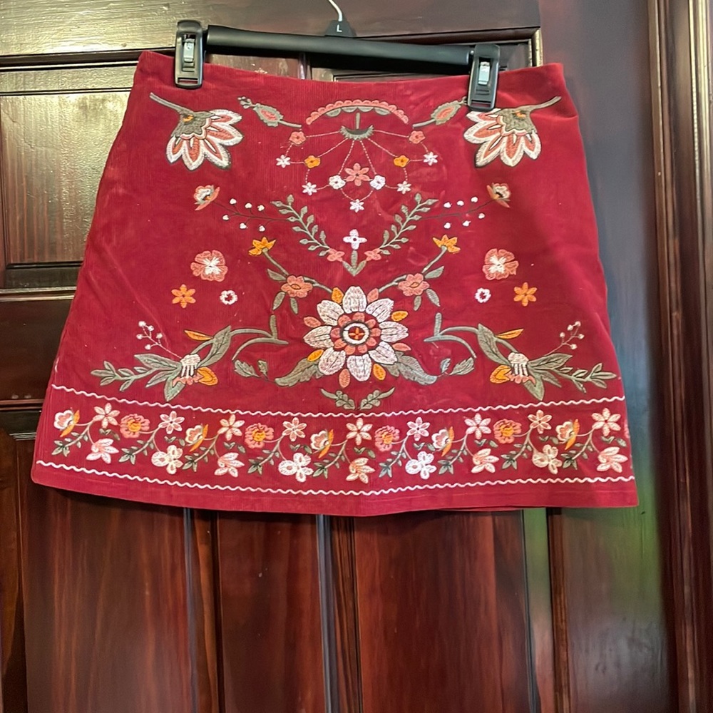 Maroon skirt with flowers embroidered